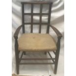 A beechwood framed child's slat back armchair. Height to seat 31cm, to back 65cm, width 39cm.