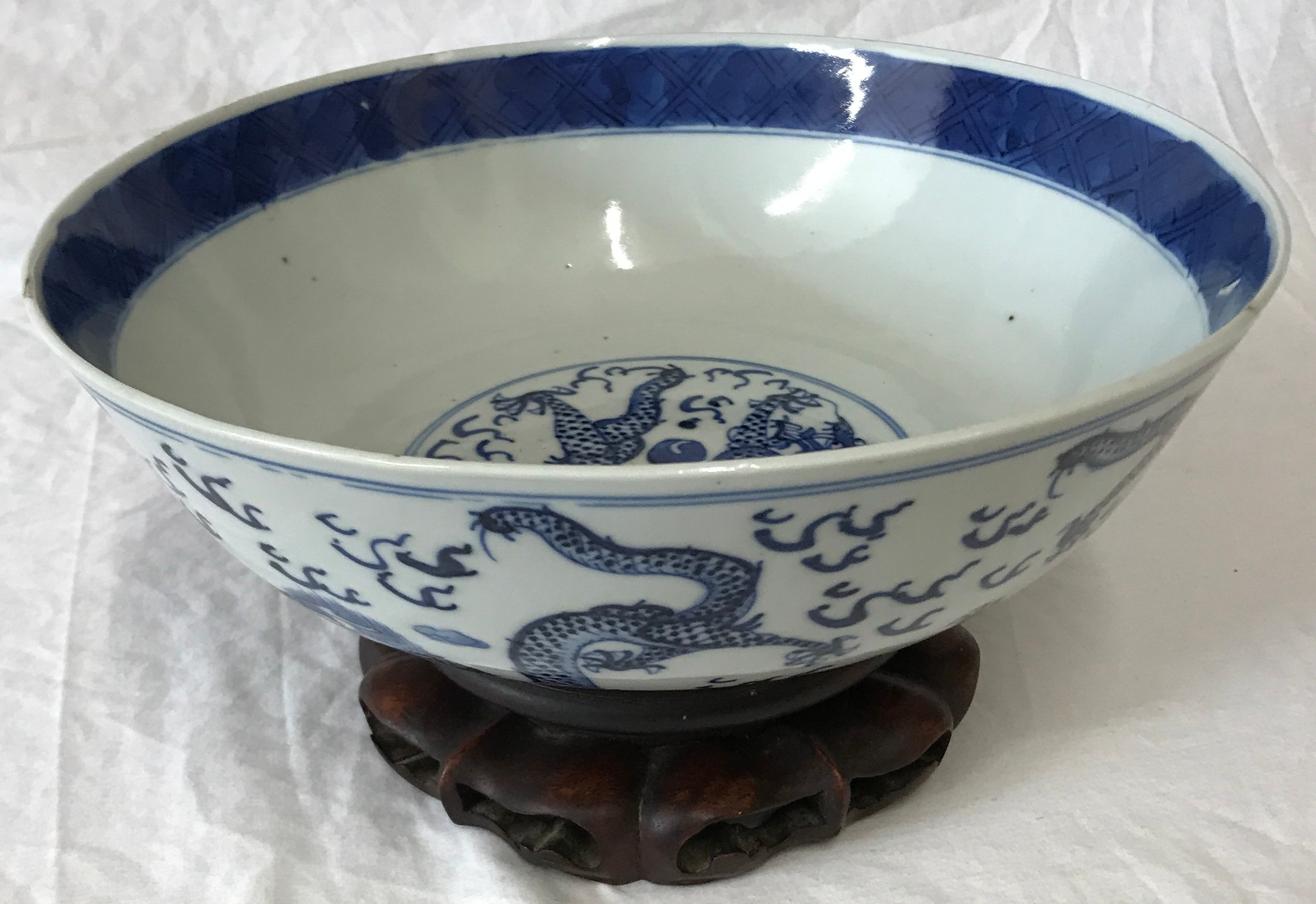 Chinese Blue and White Bowl on Wooden Stand. Bowl measures 26cms diameter, 9cms in height.