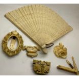 Various ivory, bone and plastic items to include plastic fan, photograph frame, pendant, brooch,