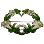 A Sterling silver and enamel Art Nouveau brooch formed by a ring of white trumpet lilies and green