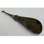 A silver shoehorn and button hook combined. Chester 1901. 56.8gm.Condition ReportHook bent.