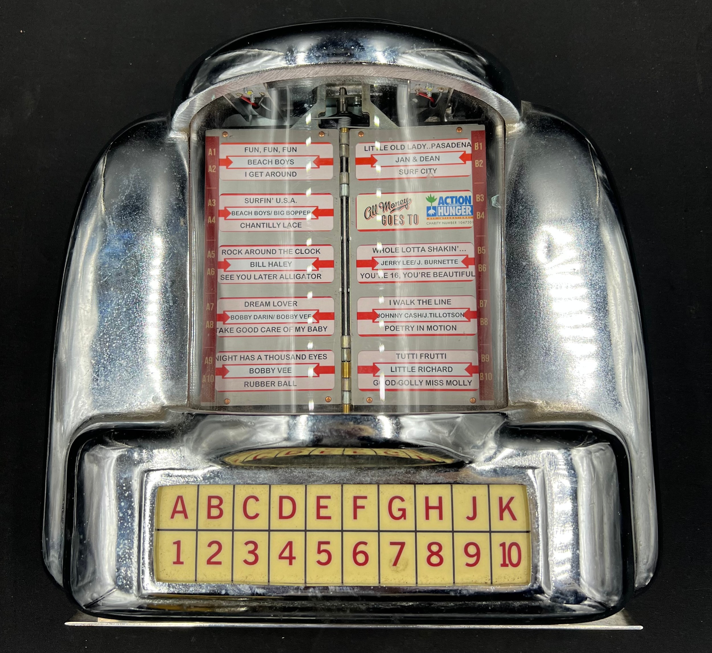A miniature coin operated wall mounted chrome jukebox. 35cm h x 31cm w. - Image 2 of 3