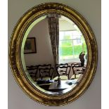 An oval gilt framed wall mirror with bevel edged glass. 68 h x 58cm w.Condition ReportGood