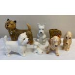 Six ceramic dogs to include a Wade money box, Sylvac hound and others unmarked together with a