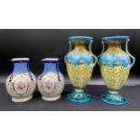 A pair of Noritake vases, decorated with panels of flowers and gilt on a blue ground, 15cm h and a