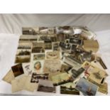 A collection of various postcards in a wooden box to include themes of war, the Lake district and