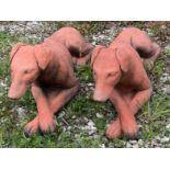 Two terracotta garden ornaments modelled as recumbent greyhound dogs. 63 cm l.