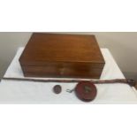 A 19thC mahogany writing box, walking stick, leather cased tape measure and a cod bottle opener.