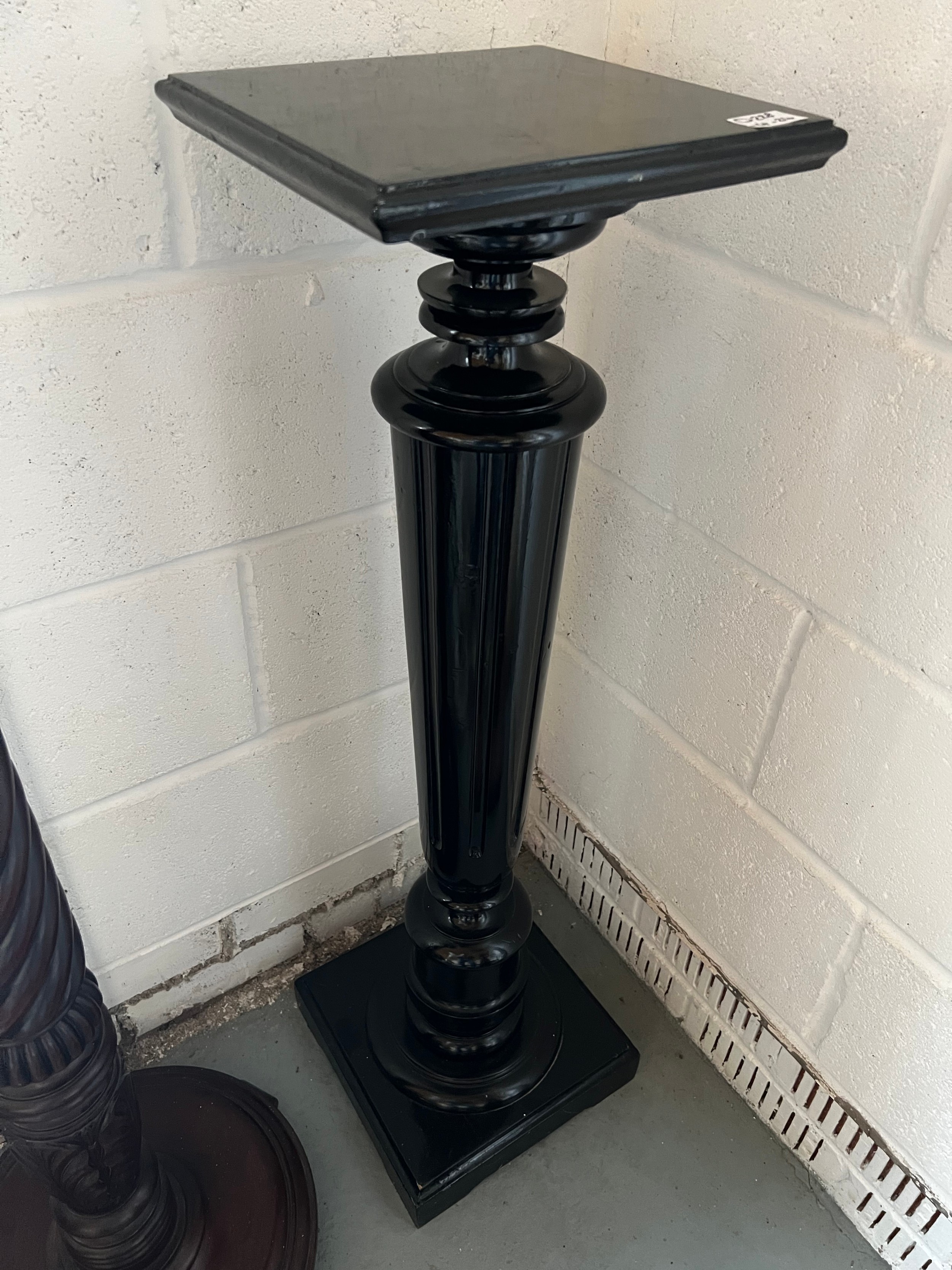 A painted black wooden torchere. 98cm h. Top 27cm square.Condition ReportGood condition.