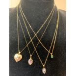 Four 9ct gold chains with pendants to include emerald, amethyst, gold-plated heart and sapphire.