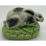 A 19thC Staffordshire rabbit with sponge work decoration, 7.5cm l.Condition ReportStress crack to