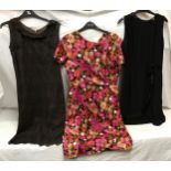 Three vintage dresses to include a brown and black lace dress, Pink floral dress and a black