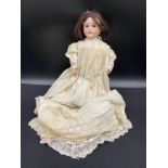 A Mah Handwerok jointed German bisque Doll, marked to the back of the neck 48cms long with