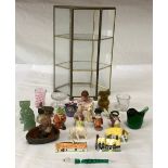 A collection of miniature items in a glass metal framed small cabinet 26.5cms h to include Schuco