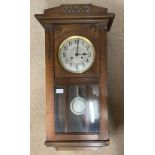 An oak cased wall clock. 80cm h.Condition ReportUntested. With key.