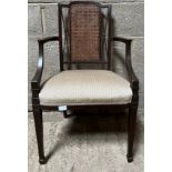An Edwardian mahogany Carver armchair with caned panel and inlaid to back.