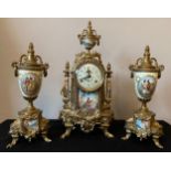 A 20thC decorative French brass and ceramic clock garniture. Clock 42cms h, vase 33cms h.Condition