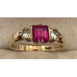 A 9 ct gold ring with central pink stone flanked by 2 diamonds. Size N. 2.3gms.
