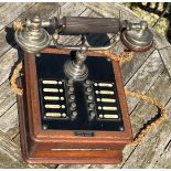 The British L M Ericsson wooden and bakelite extension telephone.
