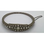 A fine quality 18ct white gold and platinum hinged bangle. 41 diamonds, 5ct total. Largest diamond