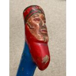 A painted stick depicting a painted bearded man. 69cm l.Condition ReportSome paint loss and scuff