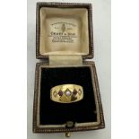 An 18ct gold ring set with seed pearls and red stones. Weight 2.6gm. Size L.Condition ReportGood