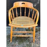 An oak cane seated spindled back chair.Condition ReportSome watermarks, otherwise good condition. .