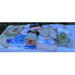 A quantity of vintage embroidered linen and tablecloths, tea cosies etc Condition ReportMost in good
