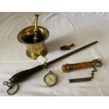 A mixed lot to include an old brass mortar and pestle, a snooker cue re-tipper, a white metal pocket