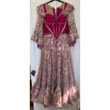 A pink coloured stage costume dress with corset top and long loose sleeve together with a separate