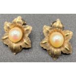 Nine carat gold clip on earrings formed as a flower with cultured pearl to centre. 3.4gm total