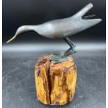 A 20thC bird ornament on log effect base. 27cm h.Condition ReportTiny chip to base.