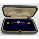 A 9ct gold bar brooch set with 3 blue stones in original presentation box. 5cm l. 1.8gm.Condition