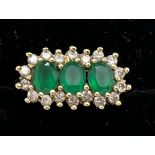 An emerald and diamond ring, 3 emeralds surrounded by diamonds set in 9ct gold. Size M. 3.9gm.