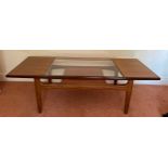 A mid century teak and glass coffee table 136 x 50cm.Condition ReportGood condition.