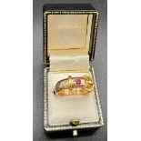 A 15ct yellow gold buckle ring set with ruby and diamond, size T, weight 11.3gm.Condition ReportGood