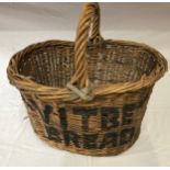 A large wicker basket with black painted words 'Vitbe Bread' 49cms h x 49cms w.Condition