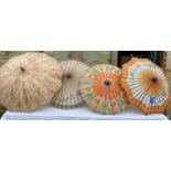 Thee painted paper parasols, fabric umbrella and a spare umbrella handle.Condition ReportSome with