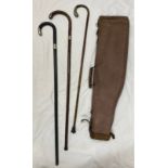 A collection of three 20thC walking canes with various silver mounts together with a rifle case.