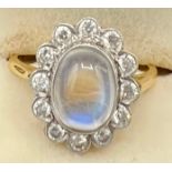 A diamond and moonstone cluster ring set in 18ct yellow gold, the central moonstone surrounded by di