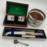 Siver to include a pair of coasters, boxed napkin rings, salt spoon and a silver handled knife.