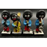 A collection of four hand painted Robertson figurines, plaster band members, two minus Robertson's