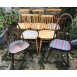 A collection of 7 chairs, 2 sets of two and a set of three, one dark wood pair Ercol with blue