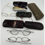 A quantity of late 19thC/ early 20thC spectacles and cases.