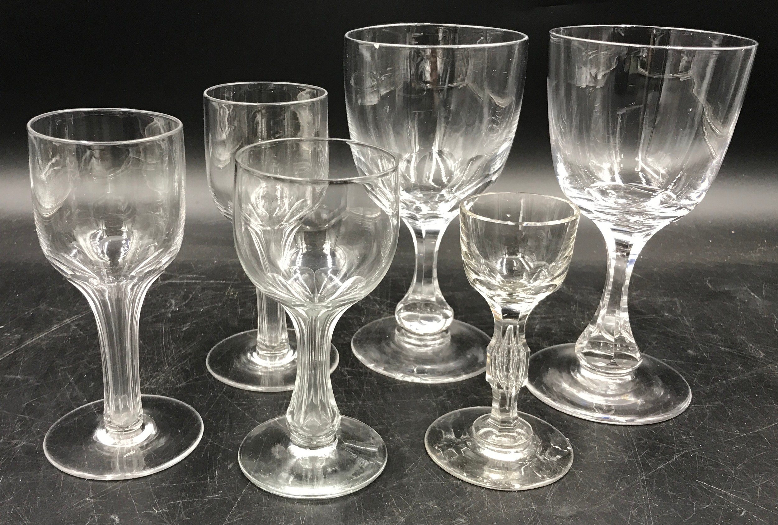 Six various drinking glasses, three with hollow stems. Tallest measuring at 17cm.