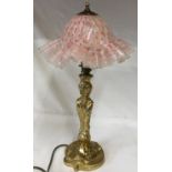A heavy brass table lamp with a glass fluted red and white shade. Ht to top of shade approx. 47cm,