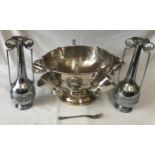 A chrome large punch bowl with cups and ladle along with two chrome vases and a fork. Punch bowl