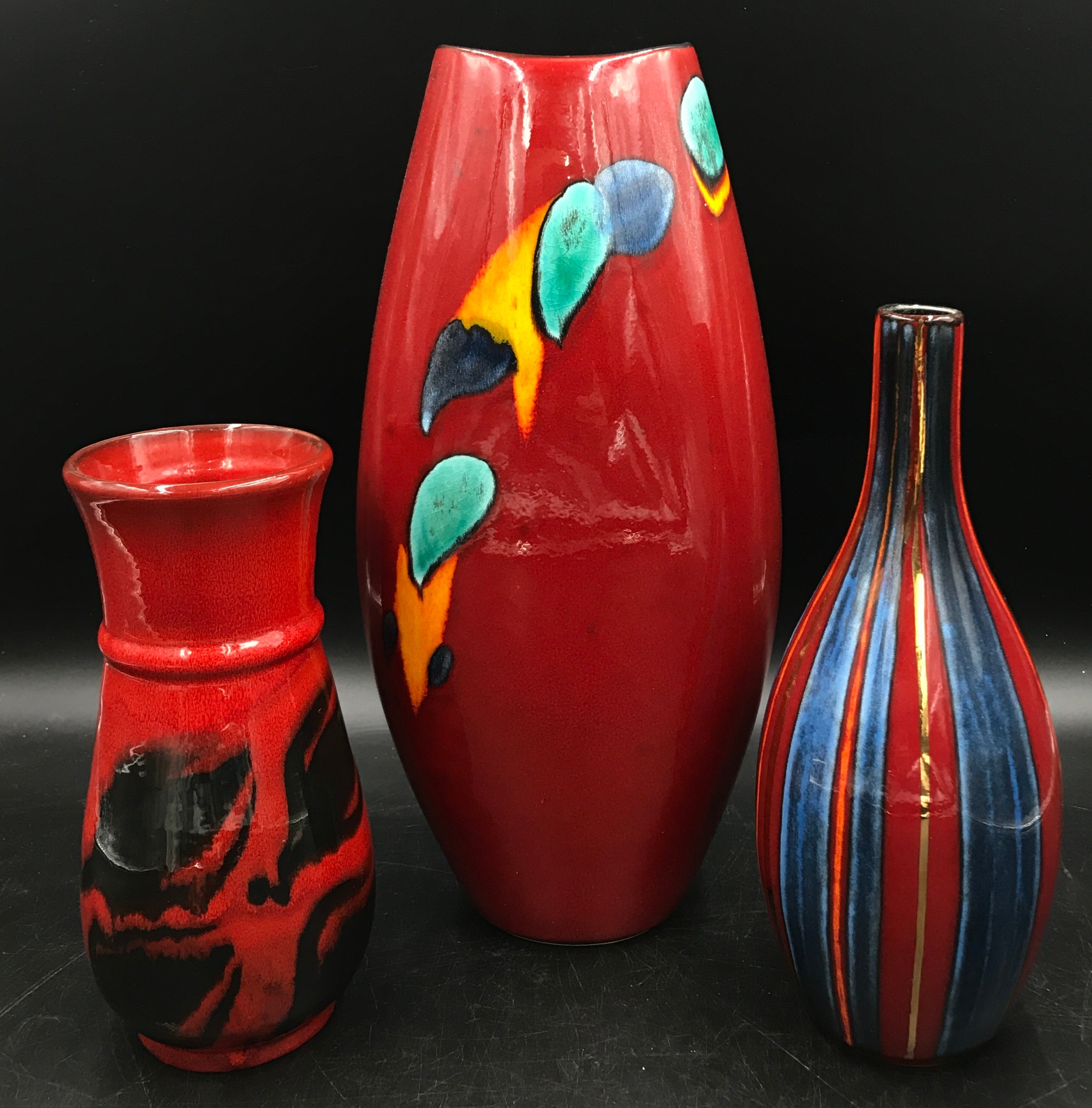 Poole pottery to include three vases of variant heights and patterns tallest 38cm h. Stripy vase