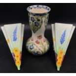 A William Moorcroft Macintyre Burslem vase with floral design 21 h and a pair of hand painted hollow