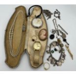 A quantity of costume jewellery to include silver charm bracelet, brooches, pocket watch etc.